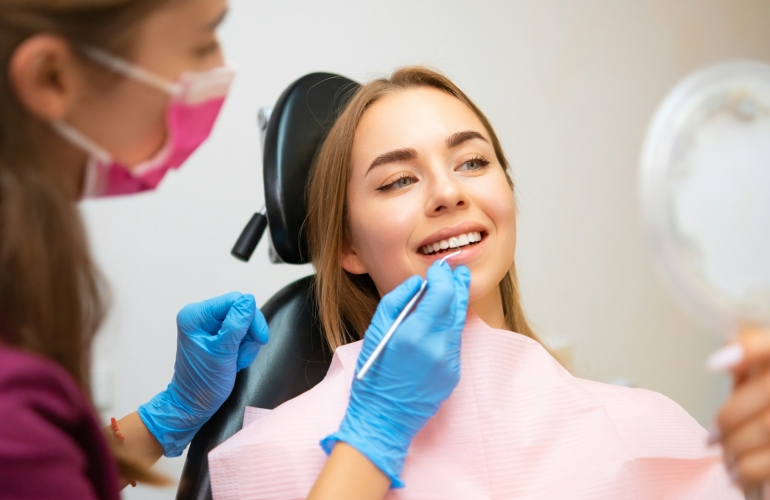 Woman patient sitting in armchair during dental treatment